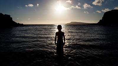 Silhouette of boy in sea